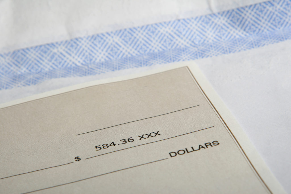 Cheque in american dollars representing business, finance, payment or investment, macro close up with copy space